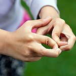 A close-up of a child's hands with hypermobile fingers