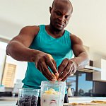 A man making a smoothie in a kitchen.