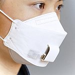 A woman wearing an EBCare smart mask, a paper mask with sensors in the area over the mouth.